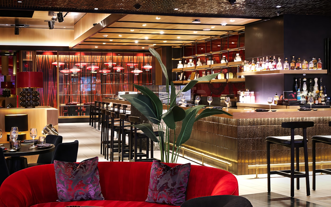 Moody luxury bar with warm amber backlighting and bottles glowing on shelves
